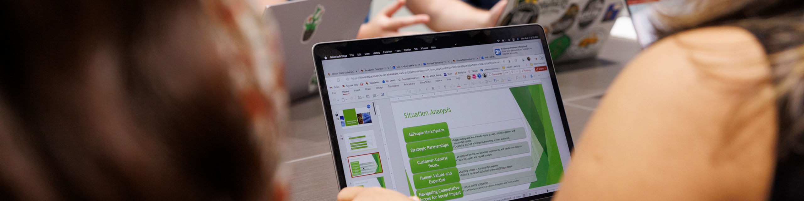 Student reviewing a powerpoint on her laptop.