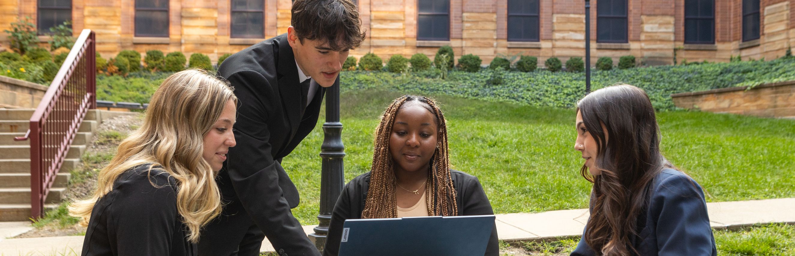 Students researching on laptop